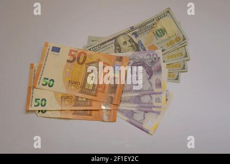 A selection of UK pound sterling, Euro and US dolar banknotes on a white background Stock Photo
