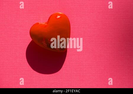 Red heart Background Valentine's Day Theme on pink paper sheet Stock Photo
