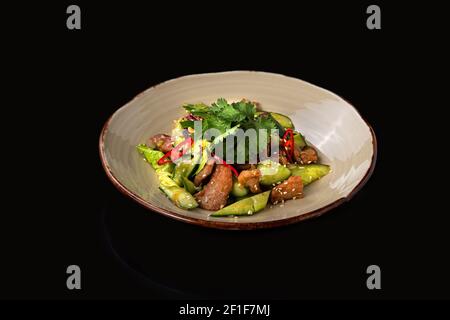 Chinese beaten cucumbers salad with pork, dark background, place for text. Stock Photo