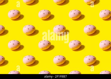 Easter seamless pattern. Pink painted egg on a yellow background. Creative packaging design in the concept of minimalism Stock Photo