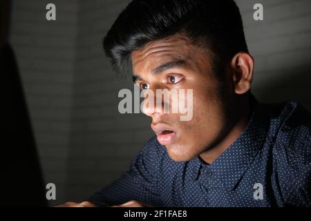 young man working on laptop stealing personal data  Stock Photo
