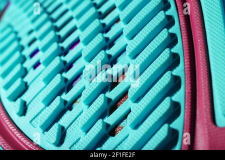 Textured blue sole of sports running shoes on a black background. Crazy modern colors. Sporty style, close-up Stock Photo