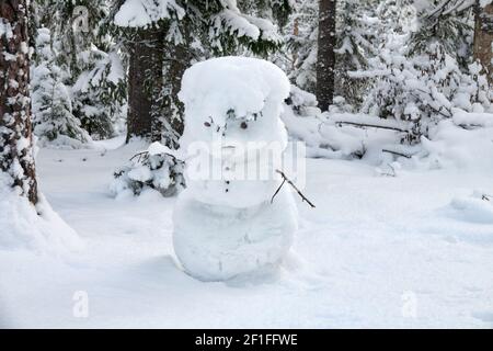 The Snow Maiden (snowman) makes his way through the snow-covered forest Stock Photo