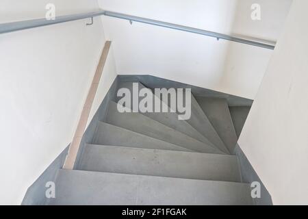 Looking down stairs inside building, L turn few steps down Stock Photo