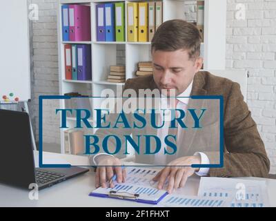 Treasury bonds concept. Man in suit works with papers. Stock Photo