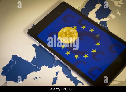 Financial concept with golden Bitcoin over smartphone, with EU flag, symbol and map Stock Photo