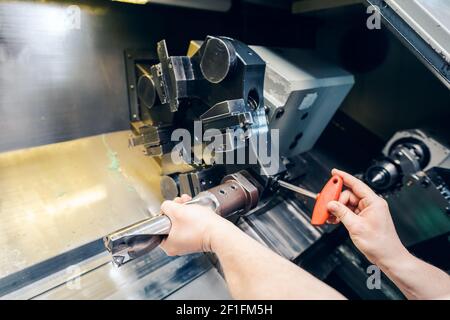 Changing the tool setup in lathe machine in production, close-up Stock Photo
