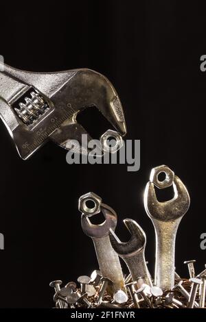 Adjustable Wrench Feeding Baby Wrenches In A Nest Of Nails Stock Photo