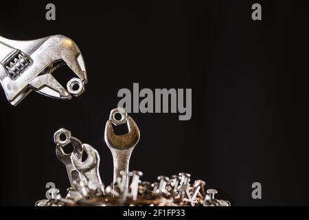 Adjustable Wrench Feeding Baby Wrenches In A Nest Of Nails Stock Photo