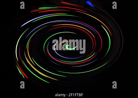 Swirling coloured lighting with a dark background Stock Photo