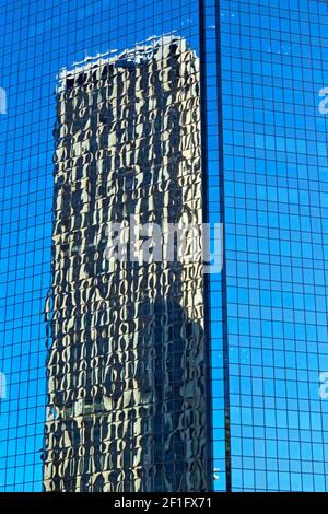 The reflex of the skyscraper in the window Stock Photo