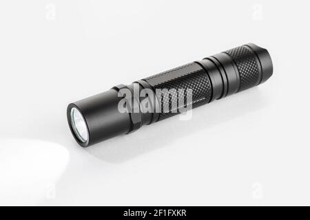 Modern aluminum Pocket Flashlight switch on isolated on white background Stock Photo