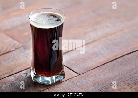 A glass of delicious craft beer served on an authentic beer glass, to be used as a background Stock Photo