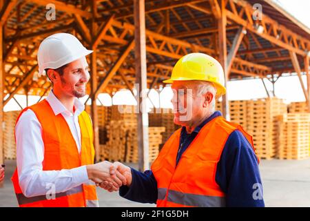 Young company manager thanks to senior foreman Stock Photo