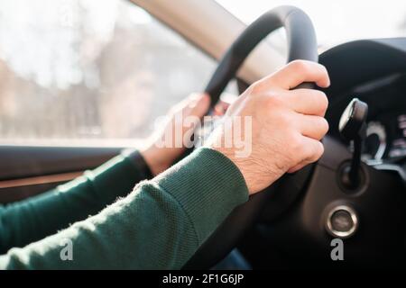 Close up mans hands on the wheel, driving a car.  Stock Photo