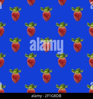 Seamless pattern with whole fresh beautiful red strawberries on solid bright blue background. Strawberries in rows. Stock Photo