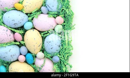 Collection of colorful Easter eggs and candy with blank white space background Stock Photo