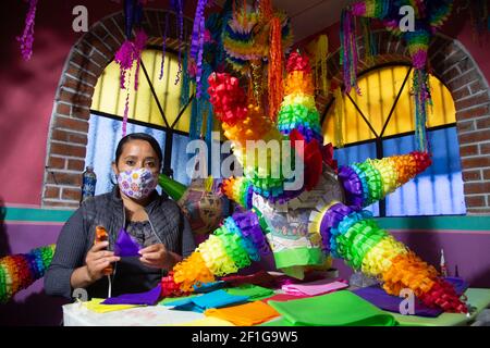 Acolman, Mexico. 07th Mar, 2021. ACOLMAN, MEXICO - MARCH 7, 2021: A woman manufactures the traditional Mexican pinata, made from a clay pot wrapped in multicolored paper, the traditional pinata takes the shape of a star, with seven points that represent the deadly sins. According to an ancient Mexican tradition on March 7, 2021 in Acolman, Mexico (Photo by Eyepix/Sipa USA) Credit: Sipa USA/Alamy Live News Stock Photo