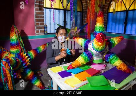 Acolman, Mexico. 07th Mar, 2021. ACOLMAN, MEXICO - MARCH 7, 2021: A woman manufactures the traditional Mexican pinata, made from a clay pot wrapped in multicolored paper, the traditional pinata takes the shape of a star, with seven points that represent the deadly sins. According to an ancient Mexican tradition on March 7, 2021 in Acolman, Mexico (Photo by Eyepix/Sipa USA) Credit: Sipa USA/Alamy Live News Stock Photo