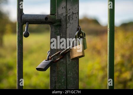An iron chain with two padlocks on a gate Stock Photo