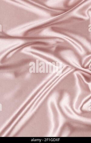 Beautiful pastel color background with drapery and wavy folds of silk satin material texture. Top view Stock Photo