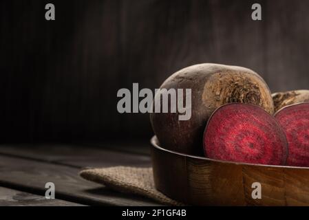 Fresh beets in Wooden plate. On a wooden background. Harvest vegetable cooking conception . Diet or vegetarian food concept. Copy space Stock Photo