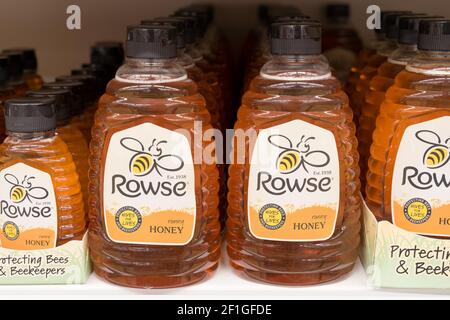 row of Rowse honey in bottles display on shelf Stock Photo