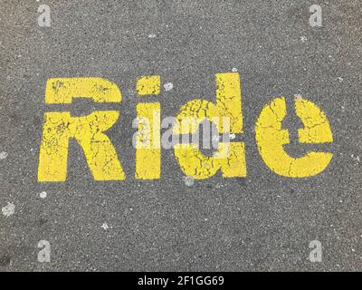 Yellow Ride inscription painted on asphalt at the drop off parking station in Zug, Switzerland Stock Photo