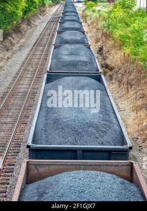 Vertical shot of a line of coal cars on a freight train.   This is a revised image. Stock Photo