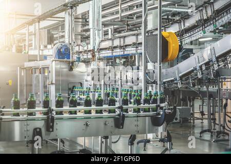Conveyor belt with juice in bottles, Beverage factory, production line process. Stock Photo