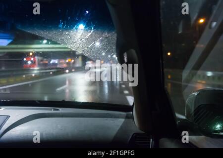 view from a driving car on a wet night highway Stock Photo