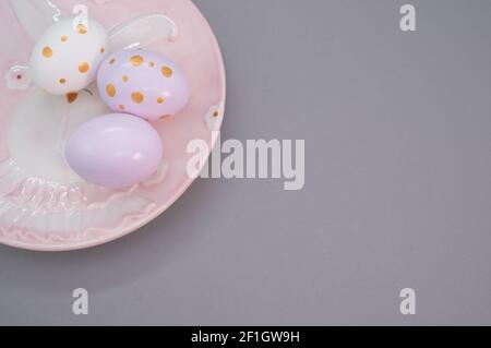 Decorated eggs in a plate isolated on purple background Stock Photo