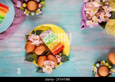 Easter dessert colorful cake with sprinkles and eggs. Top view. Stock Photo