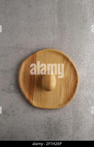 wooden egg on a wooden plate Stock Photo