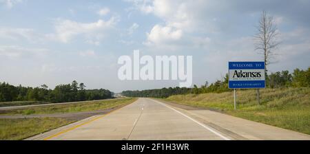 Moving Along the Highway Crossing the Arkansas State Line Stock Photo