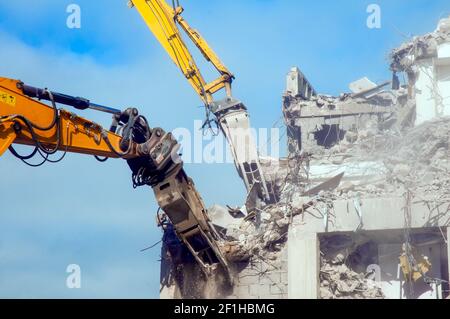 Large hydraulic jaws breaking up reinforced concrete at the demolition of Wilko store and multi storey car park Talbot Rd Blackpool Lancashire England Stock Photo