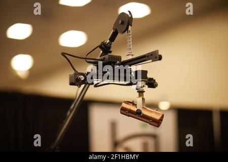 Copper microphone on remote positioning device overhead orchestral stand Musical Instrument Convention Stock Photo
