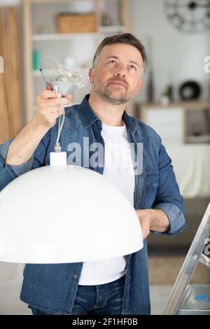 installing a spotlight in the room Stock Photo