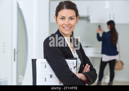 smiling businesswoman holing a clipboard Stock Photo