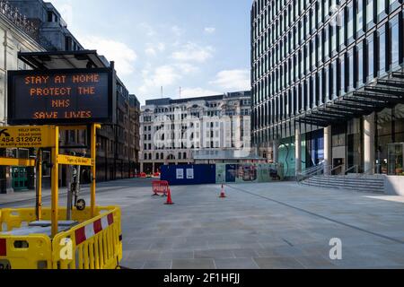 Liverpool Street, London. Covid pandemic, third lockdown. An illuminated display of 'Stay at home, protect NHS, Save Lives' against an empty street. Stock Photo