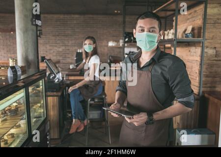 cafe owner using tablet pc Stock Photo