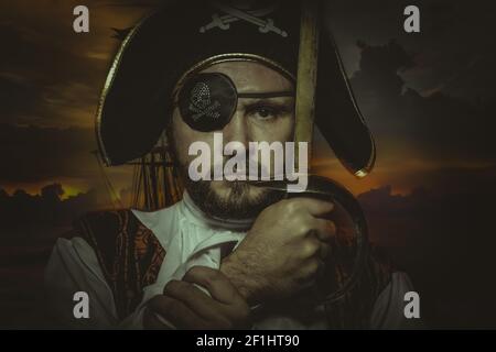 Serious, man pirate with eye patch and old hat with funny faces and expressive Stock Photo