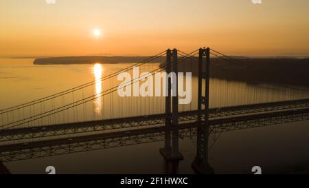 Sun Heads for the Horizon over Tacoma Narrows Bridges Stock Photo