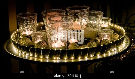 Decorative and festive Christmas holiday arrangement with glasses and candles and assorted decorativ Stock Photo