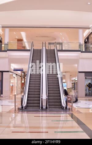 Empty mall closed early by coronavirus in Carcaixent, Valencia, Spain, on March first 2021. Electric stairs and closed stores Stock Photo