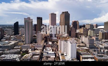 The Sun Peaks out through storm clouds lighting downtown New Orleans Stock Photo