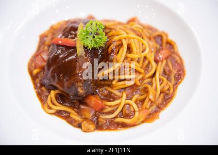spaghetti bolognese sauce with pork ribs roast on white plate, Traditional italian spaghetti Stock Photo