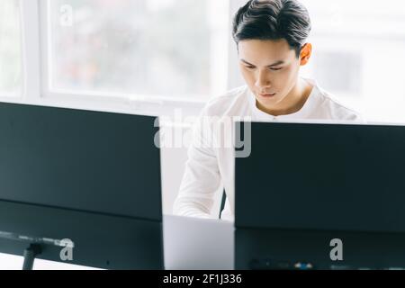 Asian programmers are focused on working to fulfill the assigned deadlines Stock Photo