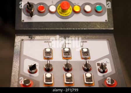 Push buttons and switches on a control panel of an industrial machine. Selective focus. Stock Photo