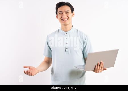 Young man holding laptop on color background Stock Photo